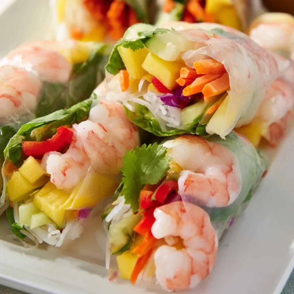 Vibrant Shrimp and Mango Spring Rolls: Colorful filling peeks through translucent rice paper.