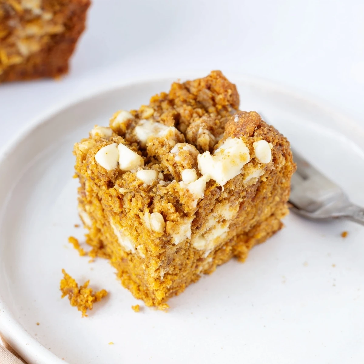 Golden, spiced pumpkin bars loaded with creamy white chocolate for a decadent dessert.  