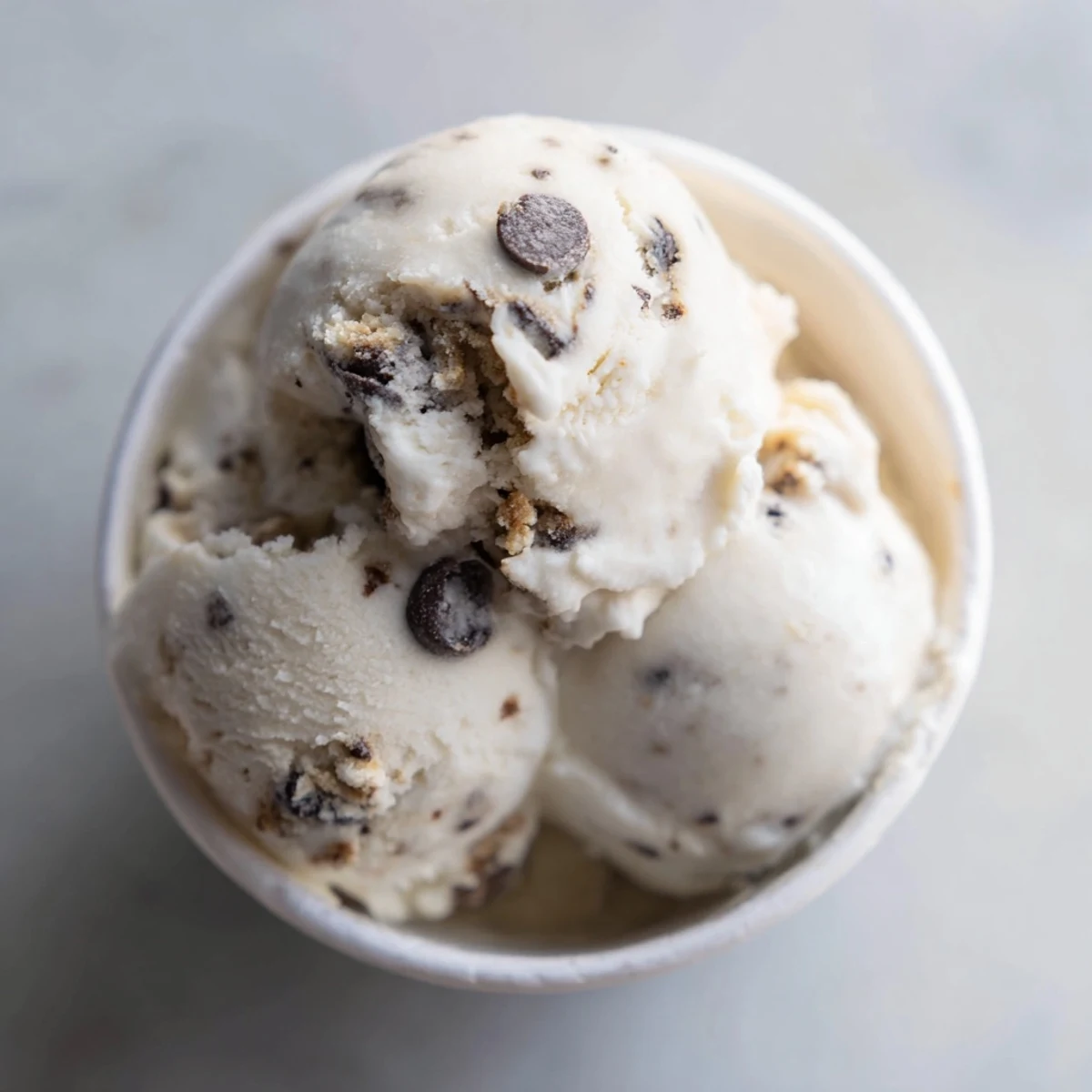 Creamy Cottage Cheese Ice Cream with Cookie Dough, drizzled with chocolate chips and sweetness.