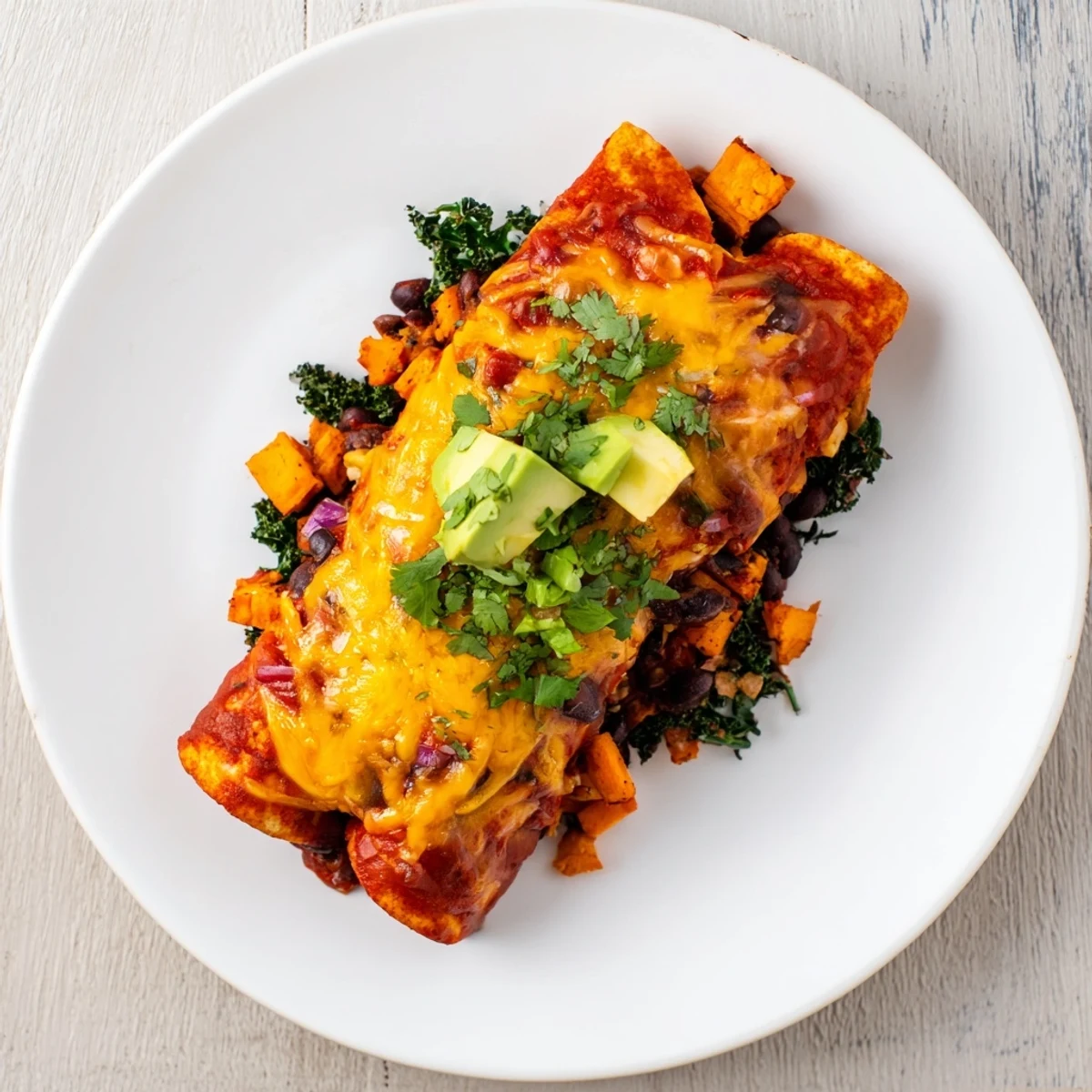 Imagine warm, flavorful One-Pan Sweet Potato, Black Bean & Kale Enchiladas, brimming with colorful vegetables.