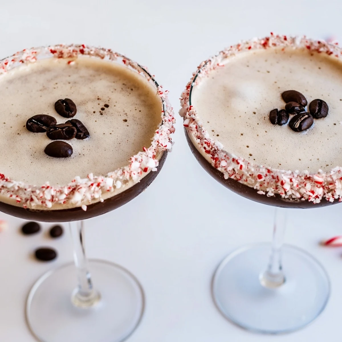 Two elegant martini glasses filled with creamy Peppermint Espresso Martinis, showcasing a chocolate peppermint rim.