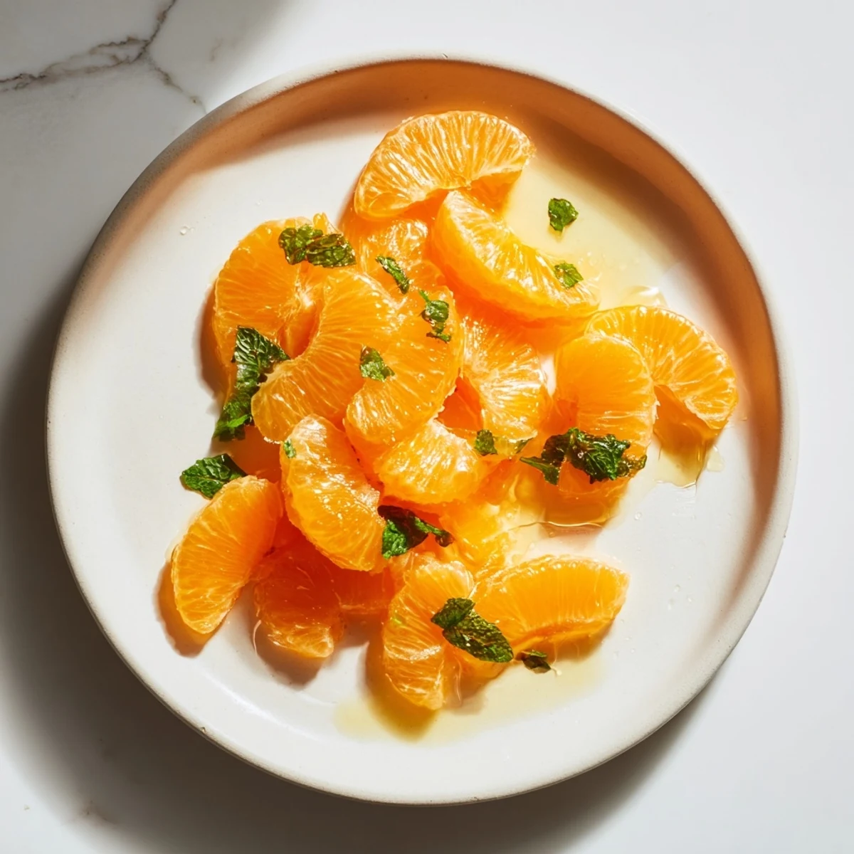 Vibrant Clementine and mint winter fruit salad, bursting with juicy citrus and refreshing mint aroma.
