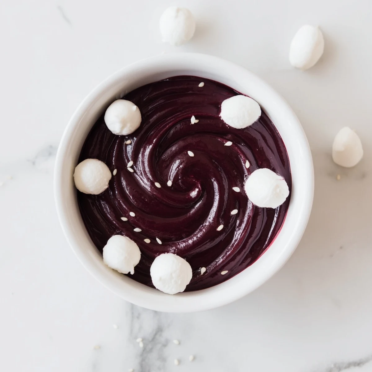 Enjoy the elegant Galaxy Spiral; dairy dessert with swirling jam, sesame stars, and goat cheese.