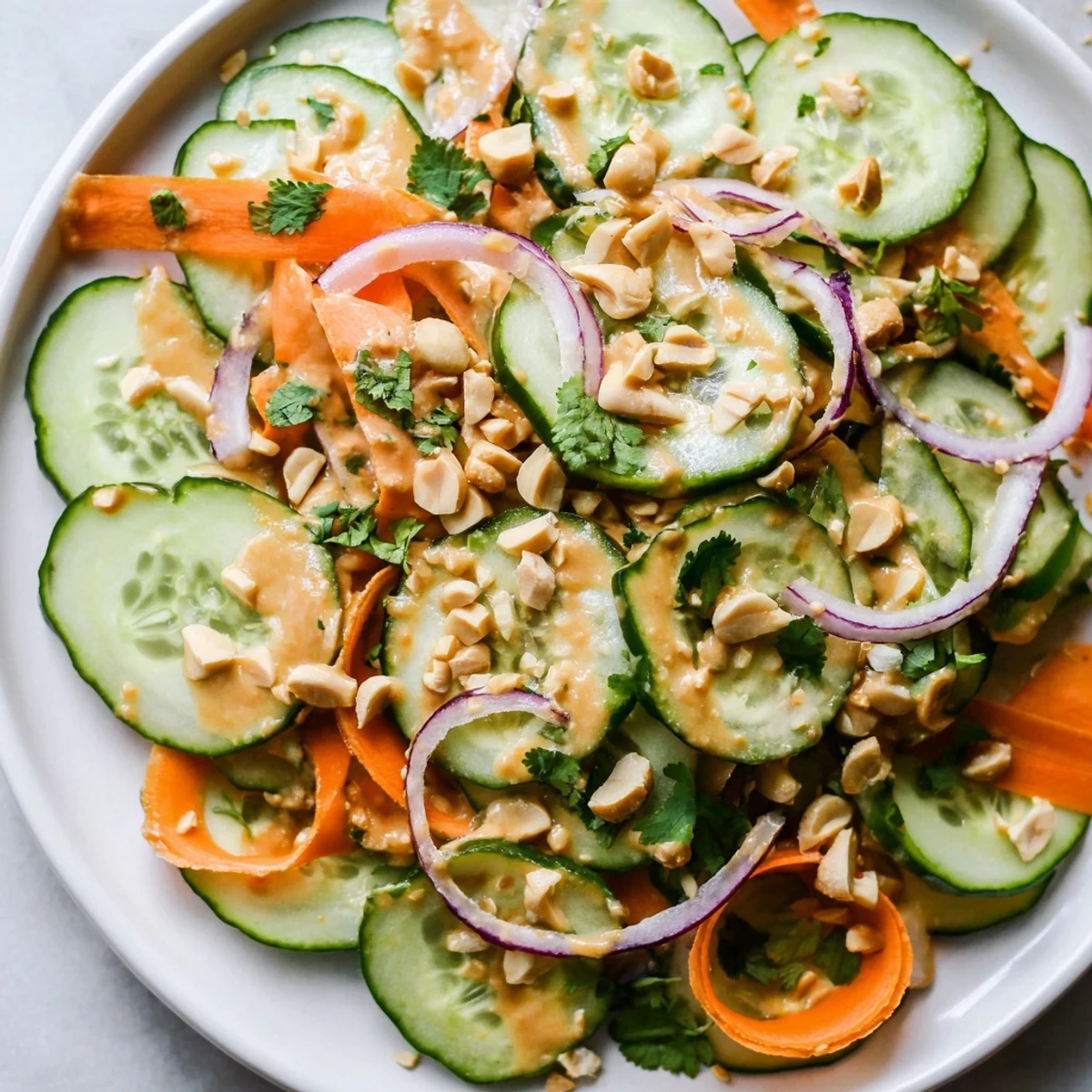 Close-up of the delicious Thai-Style Peanut Cucumber Salad, with crunchy peanuts and colorful veggies.