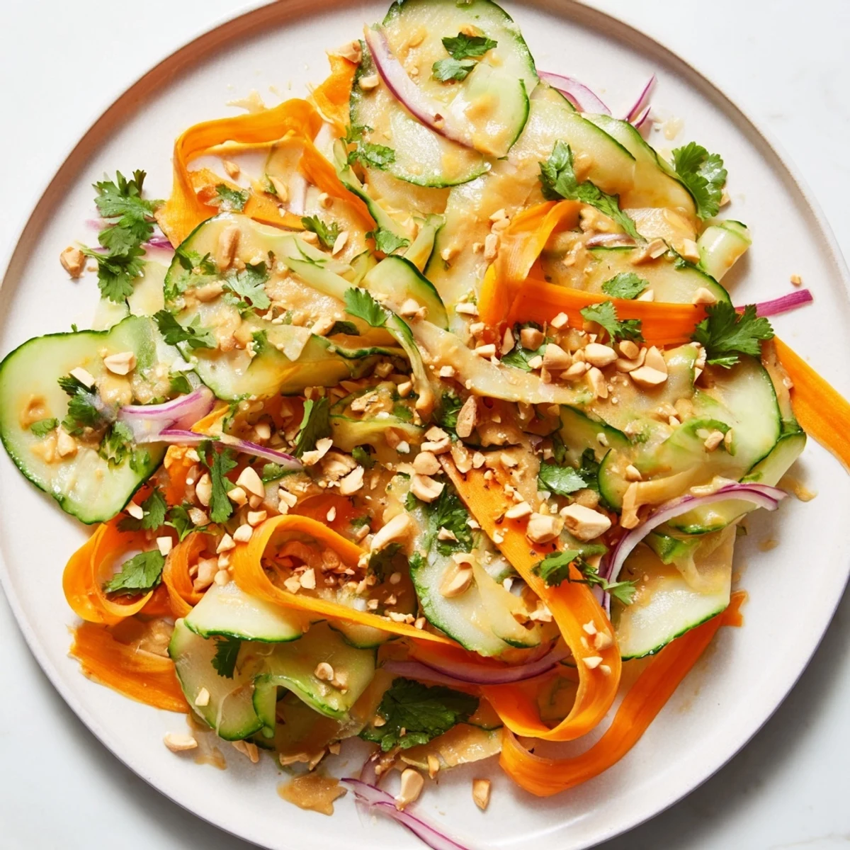 A flavorful bowl of Thai-Style Peanut Cucumber Salad with a light & savory peanut dressing.