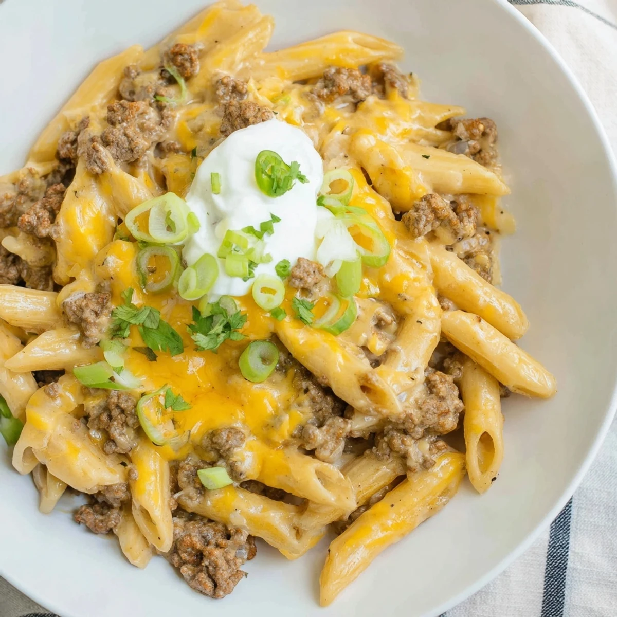 One-pot taco pasta, bubbling with melted cheddar cheese ready for a flavorful bite.