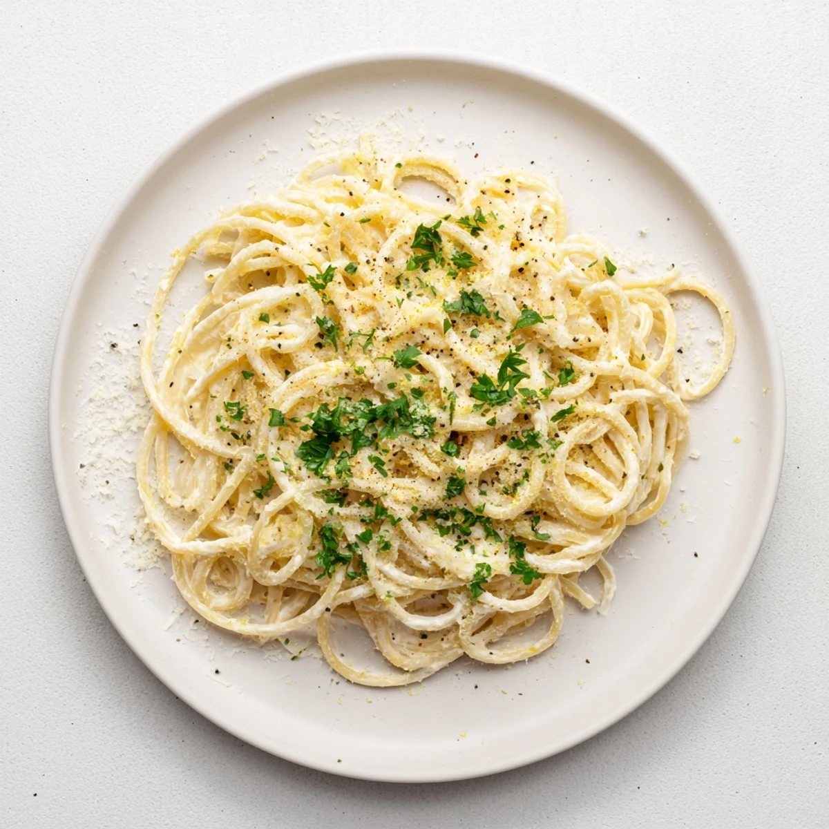 Creamy Lemon Ricotta Pasta twirls in a white bowl with glossy sauce, fresh basil, and lemon zest for a bright, weeknight Italian meal.  