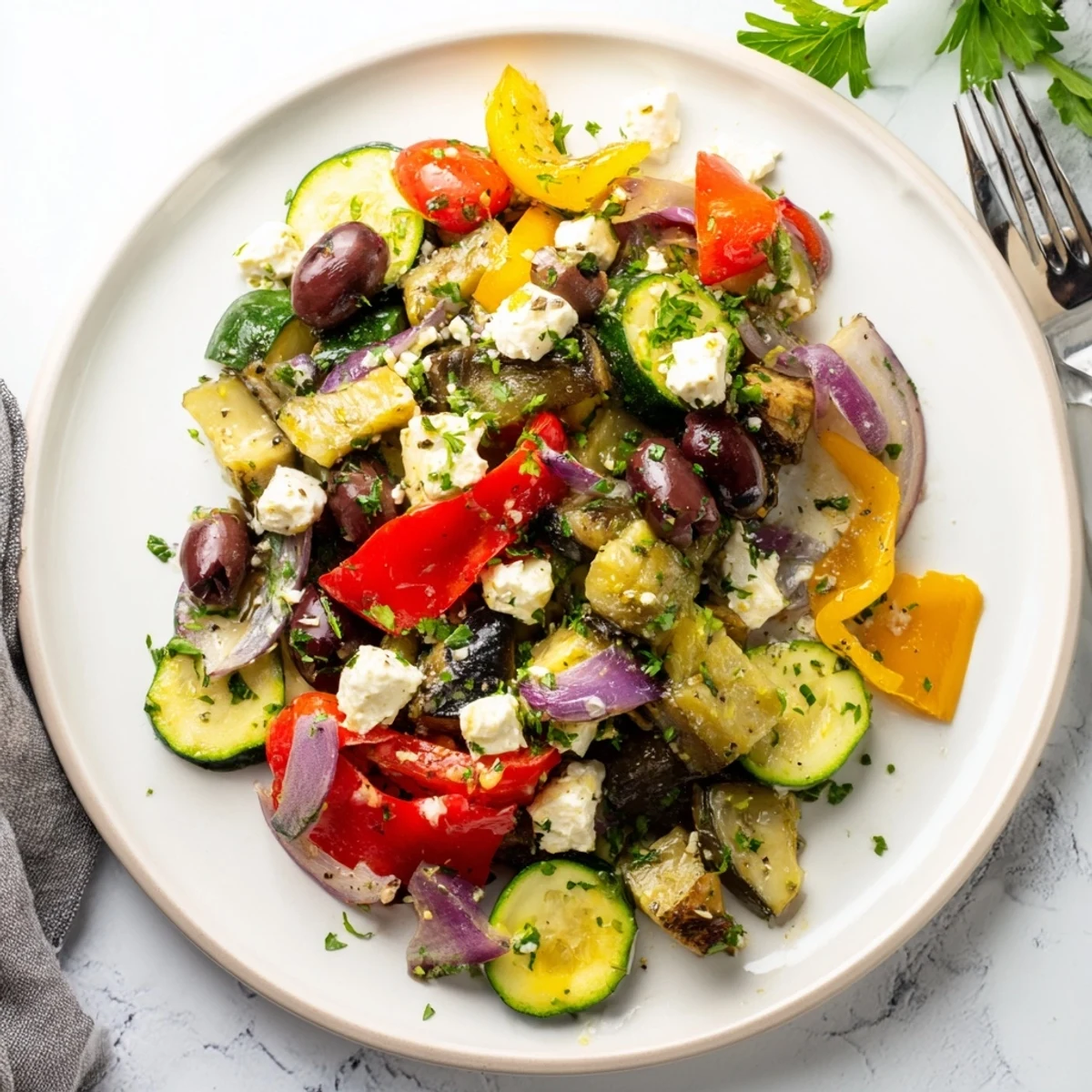 Roasted Greek salad with caramelized bell peppers, eggplant, and olives tossed in zesty lemon-oregano dressing.