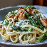 Tender chicken and crisp, oven-roasted asparagus tossed in a creamy Asiago sauce with perfectly cooked linguine.