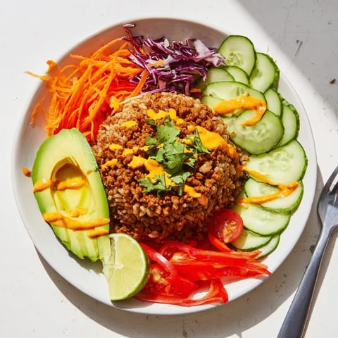 Delicious Plant-Based Meat Bowl garnished with cilantro, lime, and spicy mayo drizzle.  
