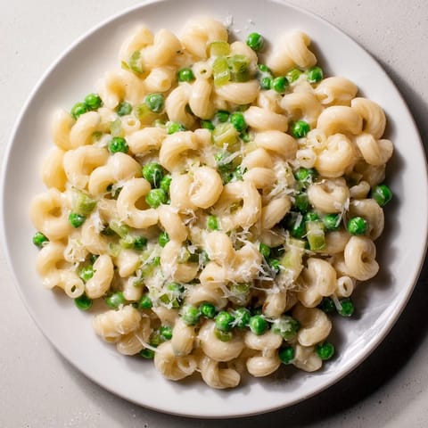 Bright green peas nestle within the cheesy Macaroni & Peas, perfect for a quick dinner.