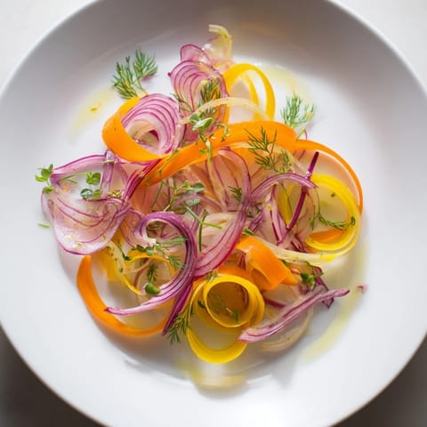 Delicate wisps of carrots and beets create an eye-catching Spinning Top salad with a bright dressing.