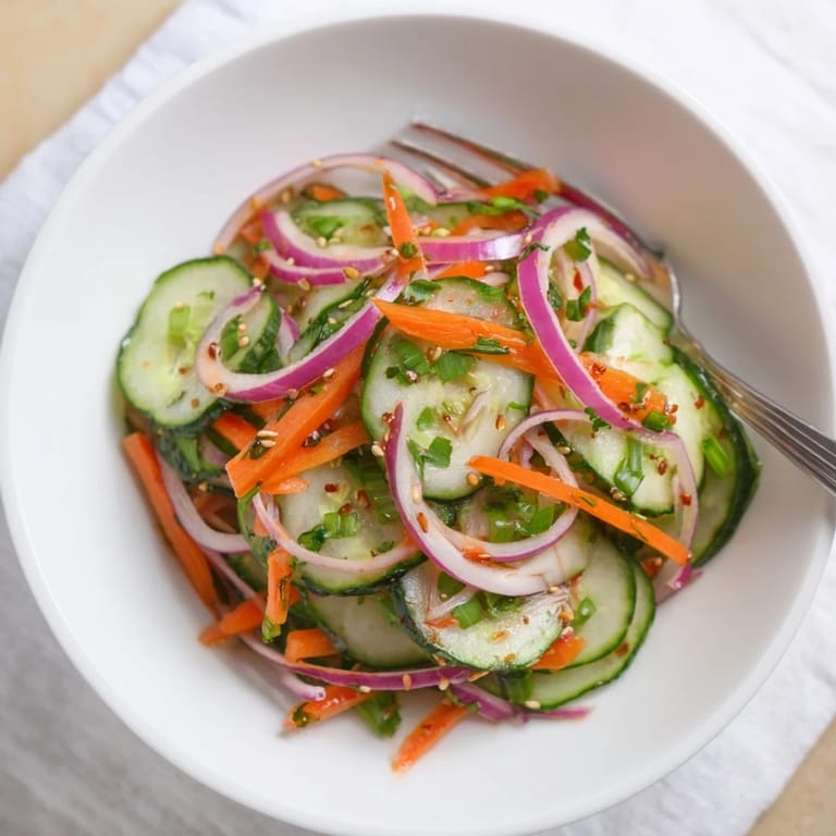 Refreshing Cucumber Salad Remix perfect for summer, tossed with tangy dressing and garnished.