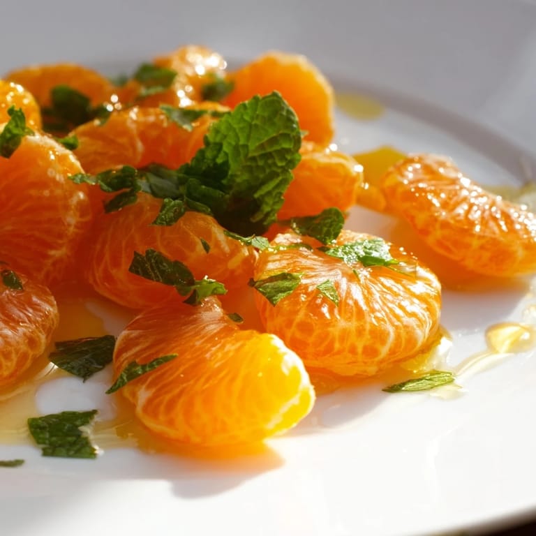 A close-up of a bright, healthy clementine and mint winter fruit salad, ready to be enjoyed.