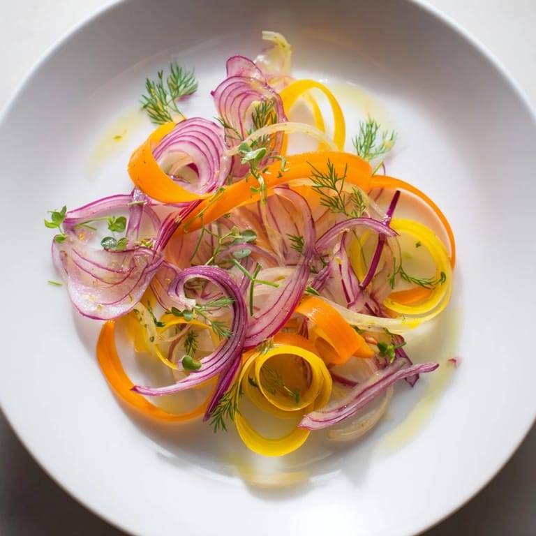 Delicate wisps of carrots and beets create an eye-catching Spinning Top salad with a bright dressing.