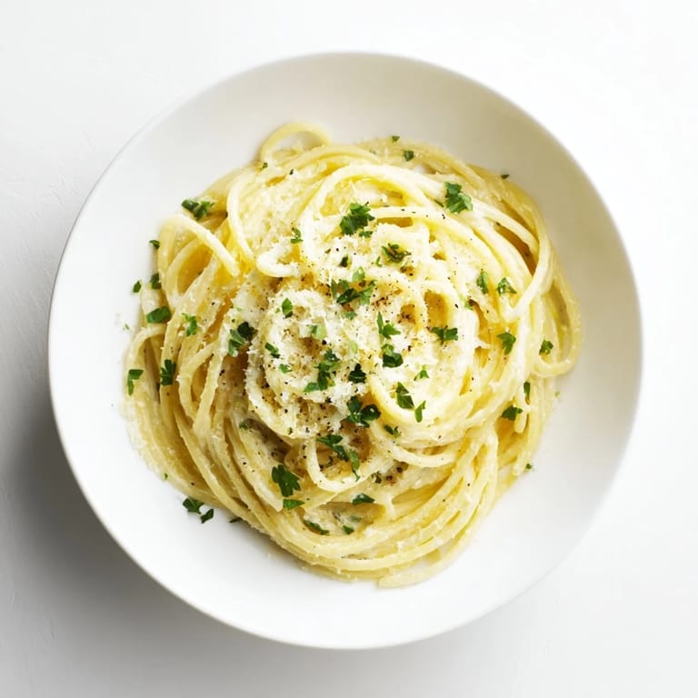 Savory Lemon Ricotta Pasta served hot, topped with grated Parmesan and cracked pepper, paired with a glass of crisp white wine.